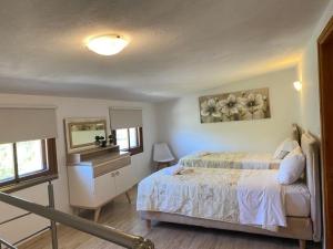 1 dormitorio con cama y espejo en PORT SEA VIEW - SKIATHOS en Skiathos