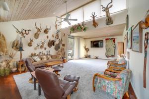 a living room with antlers hanging on the wall at Spacious Plymouth Hideaway on Acreage with Lake! in Plymouth