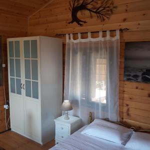 a bedroom with a bed and a window at Evdokia Country Maisonette in Áyios Mámas