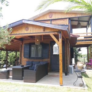 a house with a patio with a tv on it at Evdokia Country Maisonette in Áyios Mámas