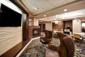 a waiting room with chairs and a fireplace at Residence Inn by Marriott Dayton Beavercreek in Beavercreek