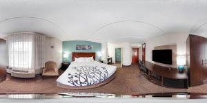 a hotel room with a bed and a tv at Sleep Inn & Suites Rehoboth Beach in Rehoboth Beach