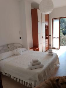 a bedroom with a bed with towels on it at Bed & Breakfast Lujocanda in Casarza Ligure