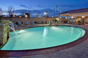 a large swimming pool with a water fountain at Residence Inn Odessa in Odessa