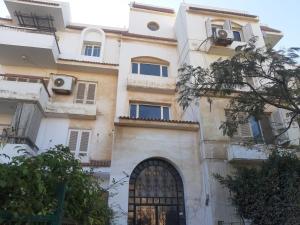 a large building with a door and a window at شقة في السادس من أكتوبر الحي المتميز in 6th Of October