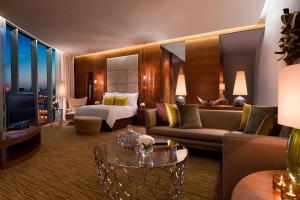 a hotel room with a couch and a bed at JW Marriott Absheron Baku Hotel in Baku