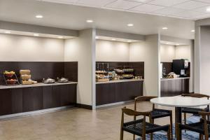 a restaurant with a table and chairs and a counter at Fairfield Inn & Suites by Marriott Amarillo Airport in Amarillo