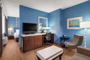 a living room with a tv and a blue wall at Fairfield Inn and Suites Chicago Downtown/ Magnificent Mile in Chicago
