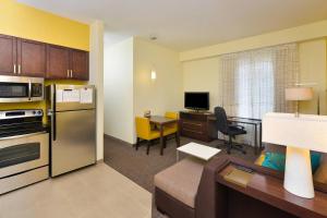 a room with a kitchen and a living room at Residence Inn by Marriott Champaign in Champaign
