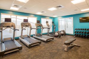 a gym with cardio equipment in a room with blue walls at Fairfield Inn & Suites by Marriott Boston Walpole in Walpole