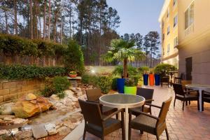 a patio with a table and chairs and a garden at Fairfield Inn & Suites Columbia Northeast in Columbia