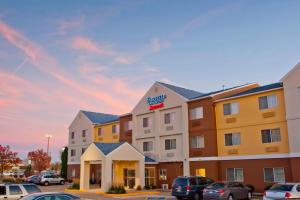 a hotel with cars parked in a parking lot at Fairfield Inn & Suites by Marriott Champaign in Champaign