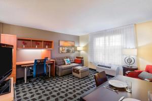 a living room with a couch and a table at TownePlace Suites Pensacola in Pensacola