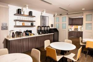 a restaurant with tables and chairs and a counter at Residence Inn Las Vegas South/Henderson in Las Vegas