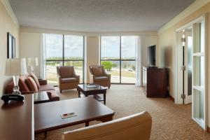 a living room with a couch and a tv at West Palm Beach Marriott in West Palm Beach