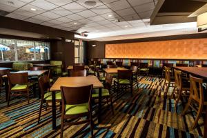 a dining room with wooden tables and chairs at Fairfield Inn & Suites by Marriott Florence I-20 in Florence