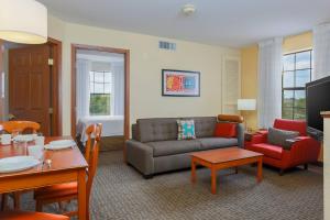 a living room with a couch and a table at TownePlace Suites by Marriott College Station in College Station