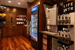 a drink refrigerator in a store with a lot of alcohol at Marriott Park Ridge in Park Ridge