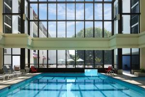 a swimming pool in a building with large windows at Marriott Park Ridge in Park Ridge