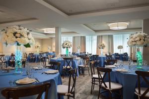 a banquet hall with blue tables and chairs and flowers at Fort Lauderdale Marriott North in Fort Lauderdale