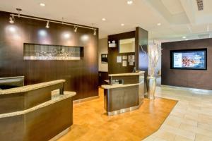 a lobby of a hotel with a counter and a tv at Courtyard by Marriott Clarksville in Clarksville