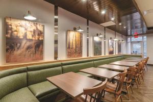 a row of tables and chairs in a restaurant at Fairfield Inn & Suites by Marriott Kansas City Shawnee in Shawnee