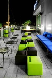 a row of tables and chairs on a patio at night at Aloft Chapel Hill in Chapel Hill