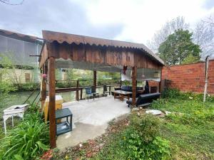a pavilion with a table and chairs in a yard at Studio St Florentin 3 in Saint-Florentin