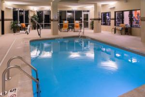a large swimming pool in a hotel lobby at Courtyard by Marriott Hot Springs in Hot Springs