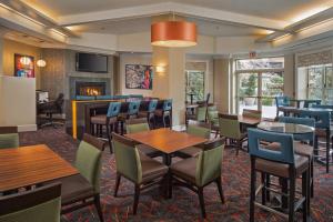 a restaurant with tables and chairs and a fireplace at Residence Inn Arlington Rosslyn in Arlington