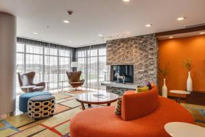 a living room with a fireplace and a couch and chairs at Fairfield Inn & Suites by Marriott Columbia in Columbia