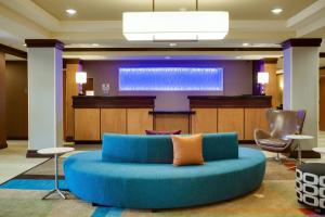 a large blue couch in a lobby with a stage at Fairfield Inn & Suites Lake City in Lake City