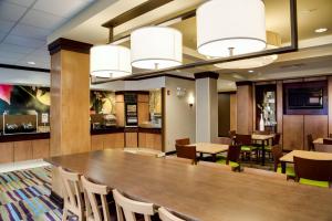 a dining room with a large table and chairs at Fairfield Inn & Suites Lake City in Lake City