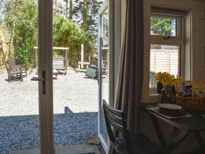 a door open to a patio with a table and a table at Lama Lodge in Hawkshead