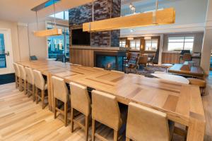 a large dining room with a large wooden table and chairs at Residence Inn Upper Marlboro Joint Base Andrews in Capitol Heights