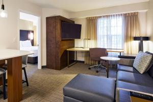 a hotel room with a couch and a table and a bed at Residence Inn Eugene Springfield in Eugene