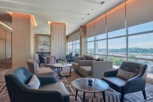 a hotel lobby with couches and tables and large windows at Fairfield by Marriott Bintulu Paragon in Bintulu