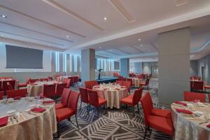 a banquet hall with tables and chairs and a screen at Fairfield by Marriott Bintulu Paragon in Bintulu