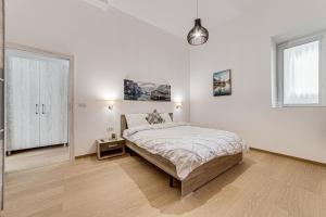 a white bedroom with a large bed and a window at Old Town Luxurious Apartment in Arad +28 photos