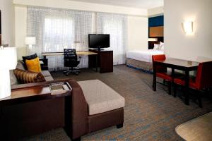 a hotel room with a bed and a living room at Residence Inn by Marriott Cleveland Beachwood in Beachwood