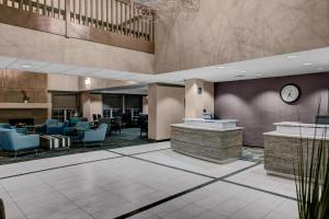 a lobby with chairs and a clock on the wall at Residence Inn by Marriott Cleveland Beachwood in Beachwood