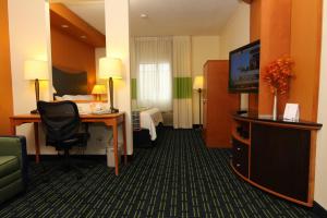 a hotel room with a desk and a television at Fairfield Inn & Suites Fargo in Fargo