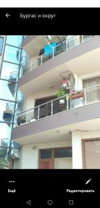 a building with a balcony with flowers on it at Smile in Burgas
