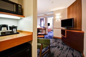 a hotel room with a kitchen and a living room at Fairfield Inn and Suites by Marriott North Platte in North Platte