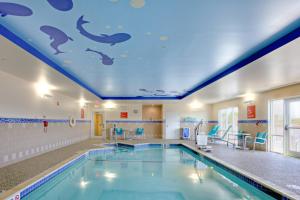 a swimming pool with a dolphin mural on the ceiling at TownePlace Suites by Marriott Wareham Buzzards Bay in Wareham