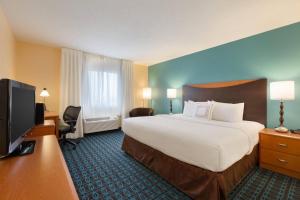 um quarto de hotel com uma cama grande e uma televisão de ecrã plano em Fairfield Inn & Suites Bismarck North em Bismarck