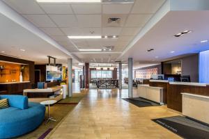 an office lobby with a blue couch and a bar at Fairfield Inn & Suites by Marriott Butte in Butte