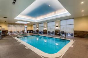 a large swimming pool in a hotel lobby at Fairfield Inn & Suites by Marriott Butte in Butte