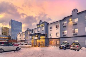 a hotel with cars parked in a parking lot at Four Points by Sheraton Anchorage Downtown in Anchorage