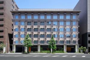 京都的住宿－The Chapter Kyoto, a Tribute Portfolio Hotel，前面有树木的办公楼